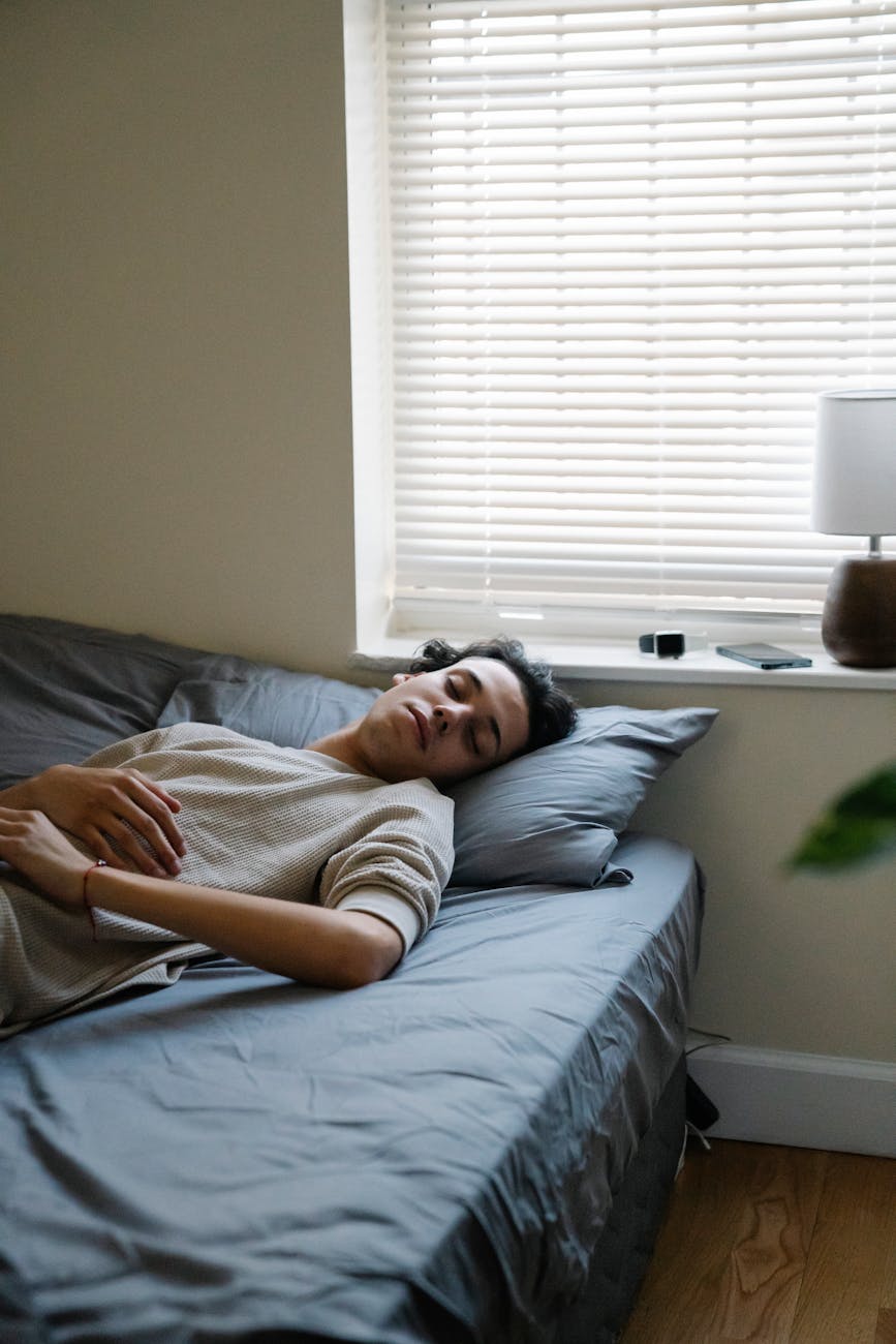 man relaxing in bedroom in morning